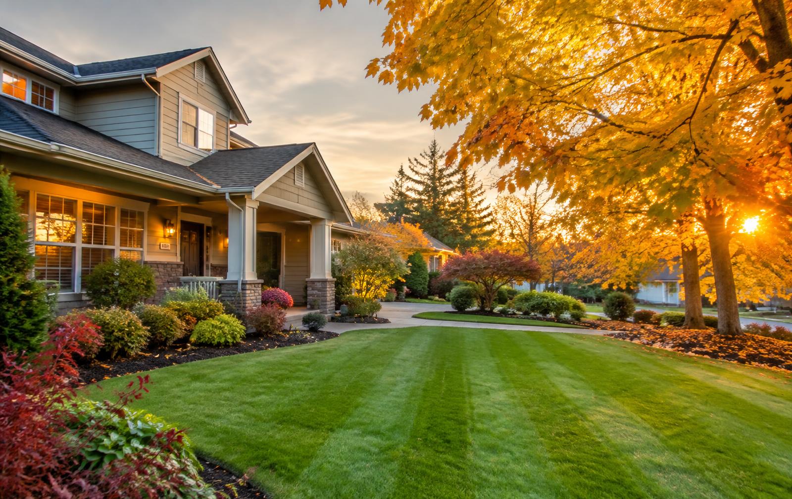 Clean striped lawn and tidy garden beds in autumn